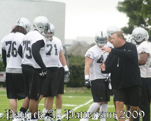 Tom Cable instructs the Raiders offensive line